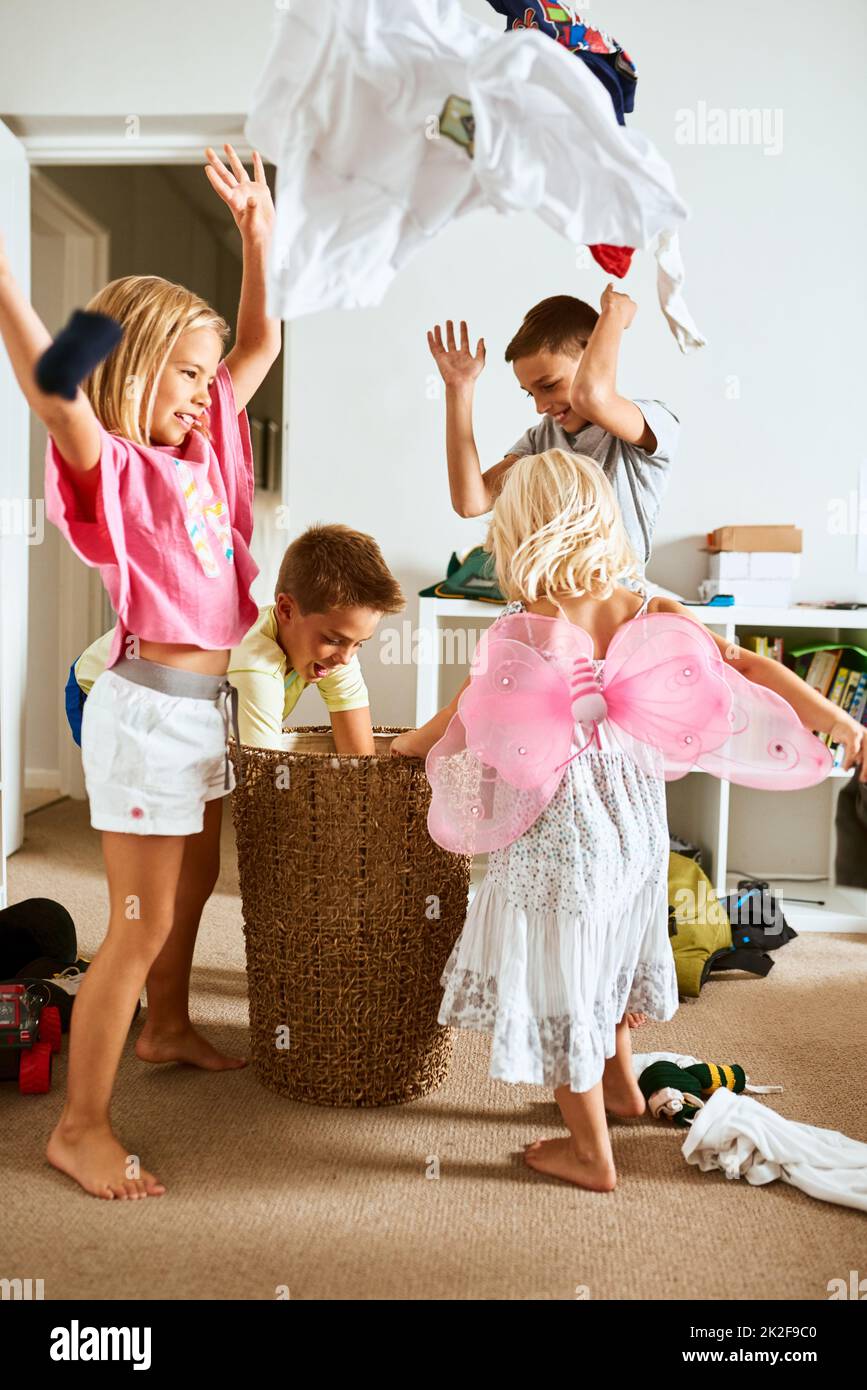 Its raining clothes. Shot of little siblings throwing laundry in the