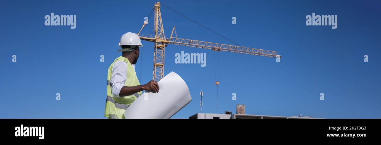 African American architect compares building to drawings Stock Photo