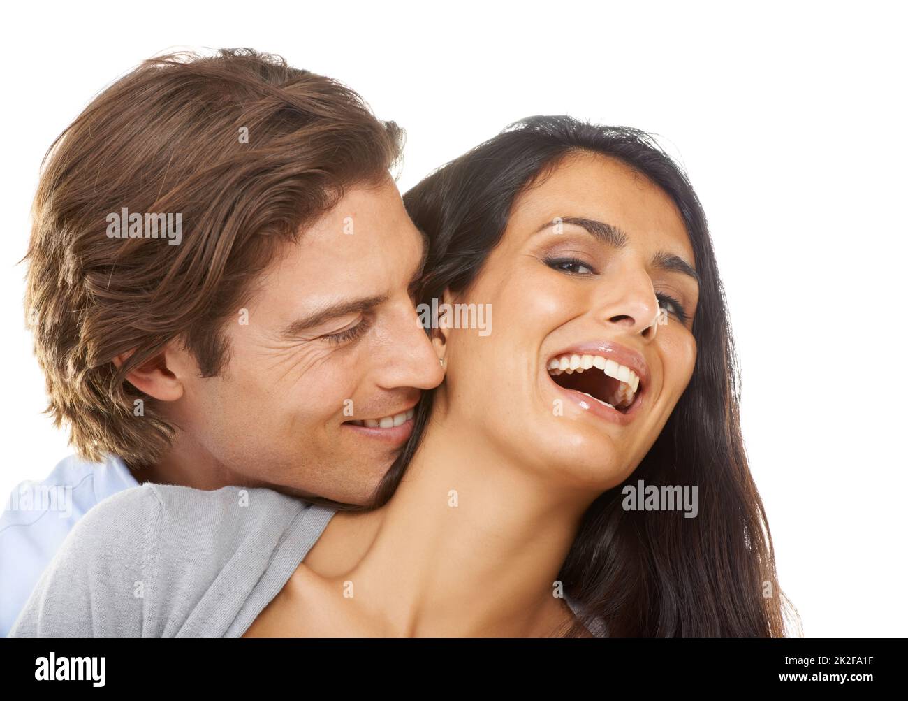 Hes a tease. Portrait of a multi-ethnic couple isolated on a white background. Stock Photo