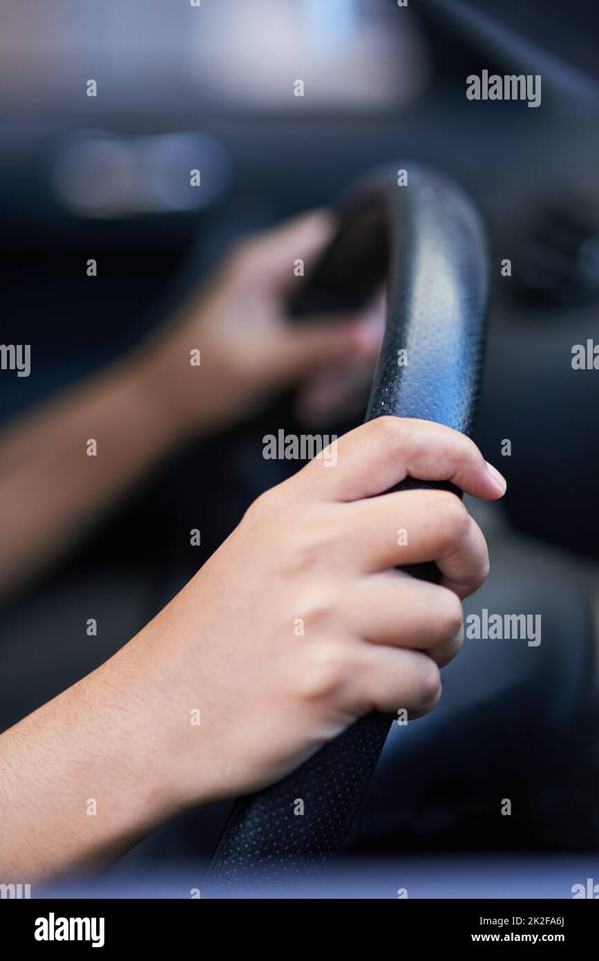 Steering in the right direction. Shot of hands holding onto a steering