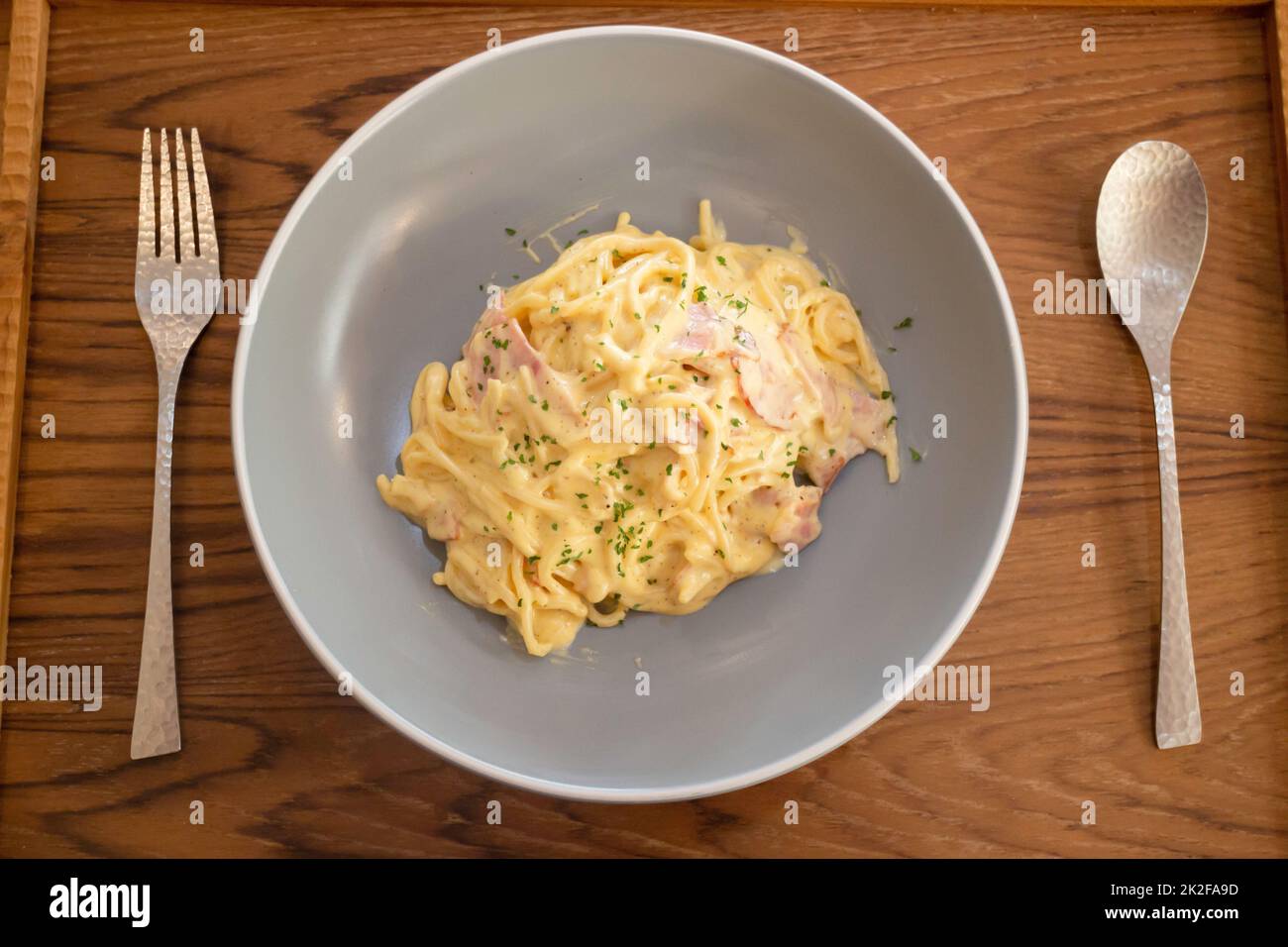 Pasta dish on wooden table Stock Photo