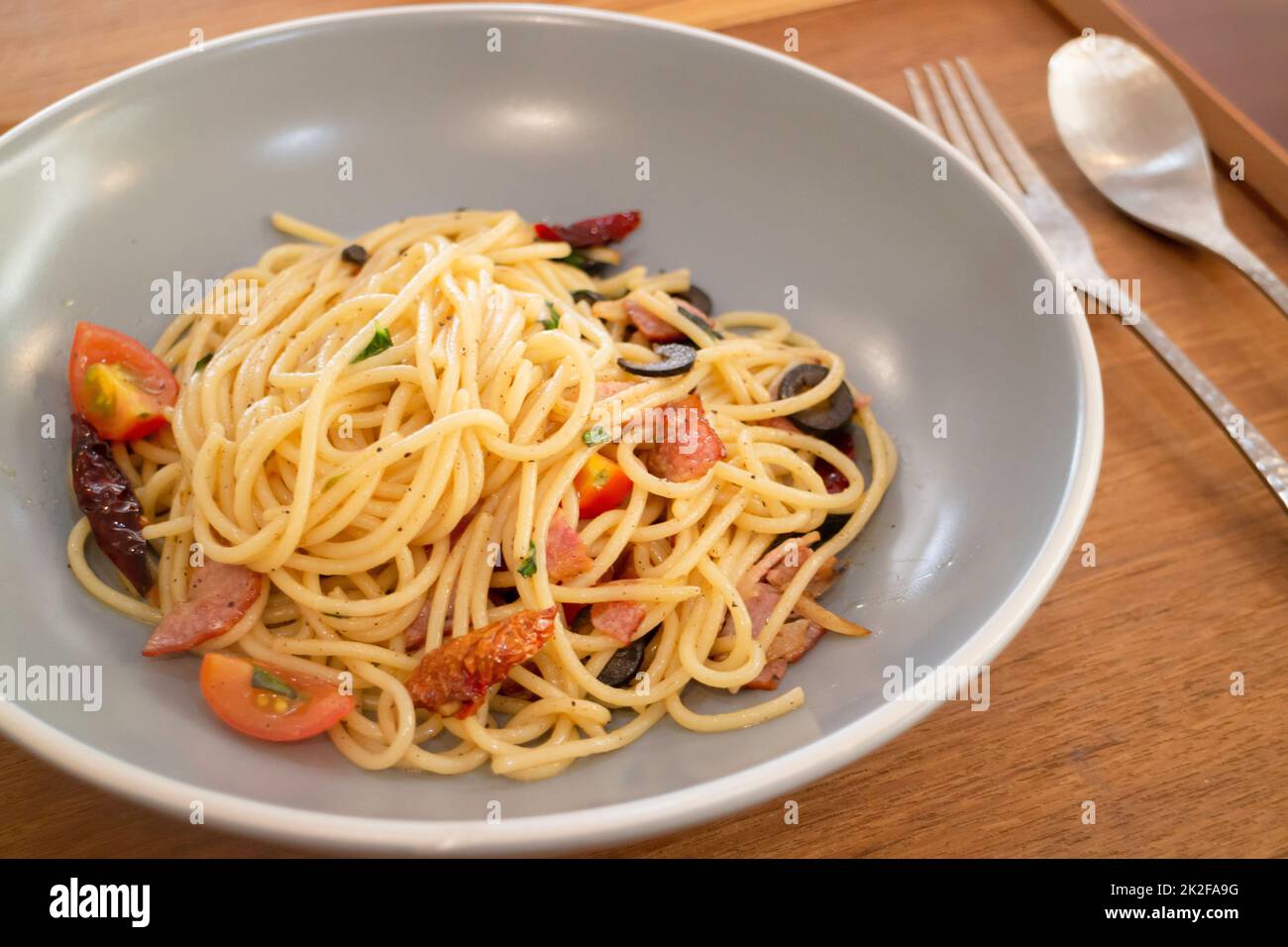 Pasta dish on wooden table Stock Photo