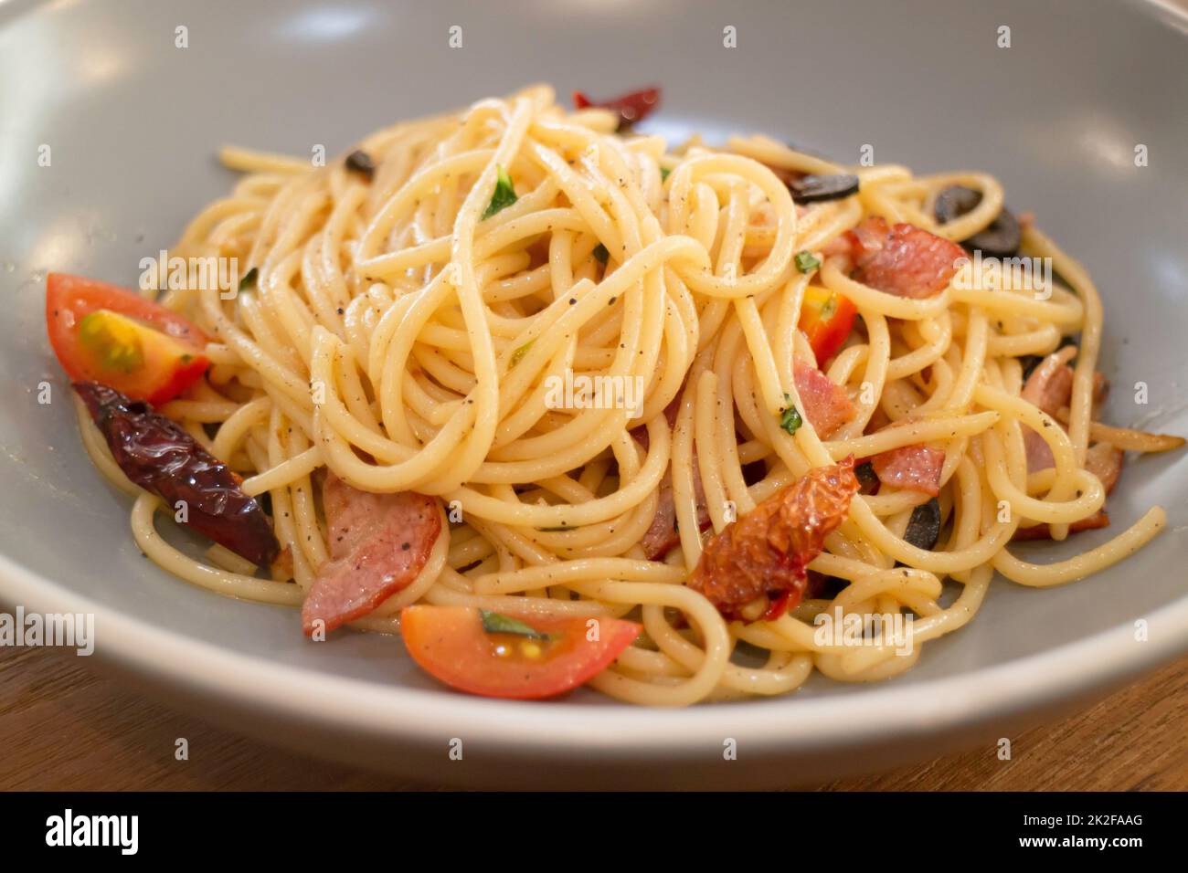 Pasta dish on wooden table Stock Photo