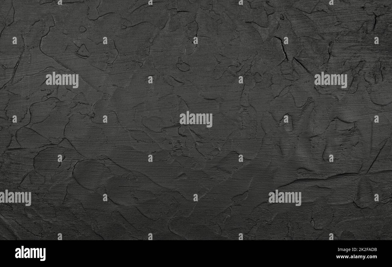 Black uneven grunge surface abstract background Stock Photo