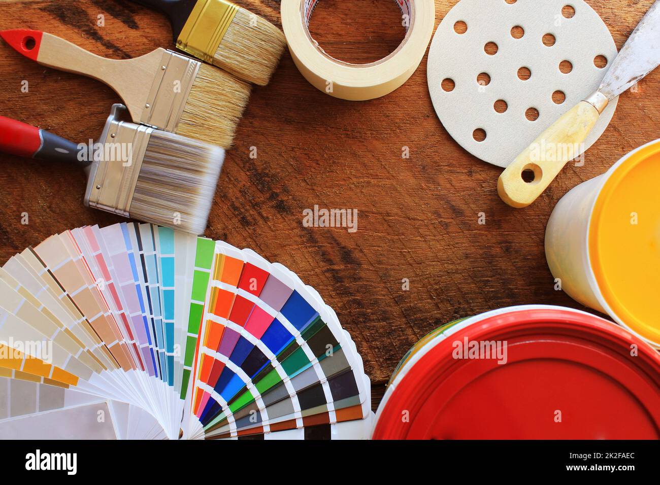various painting tools, accessories and color samples for home renovation on wooden background Stock Photo