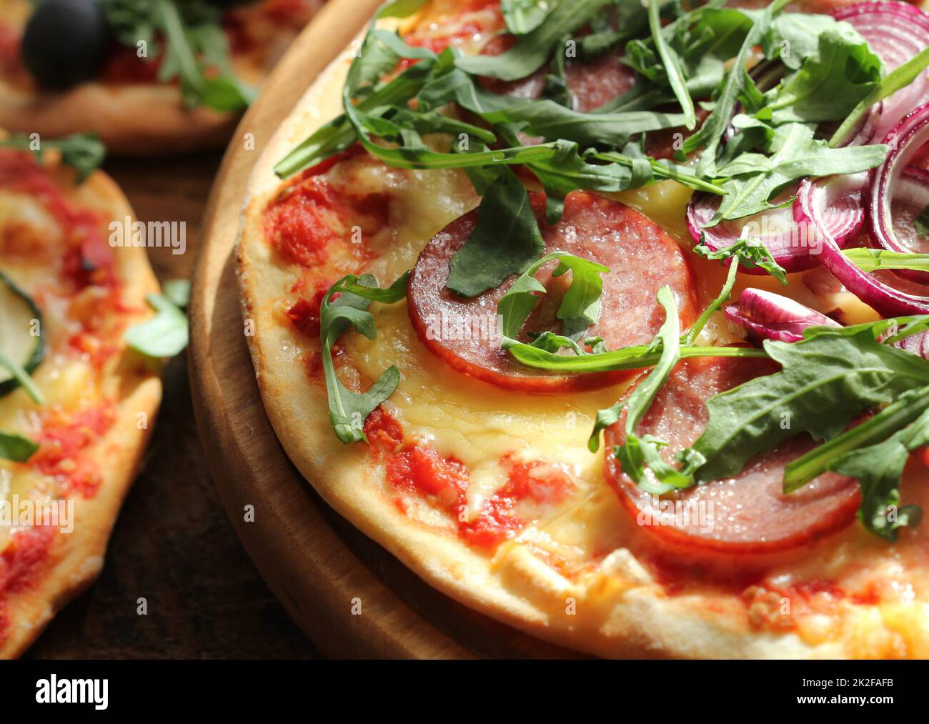 Different variations of pizza.Pizza with sausage, zucchini, olives ...