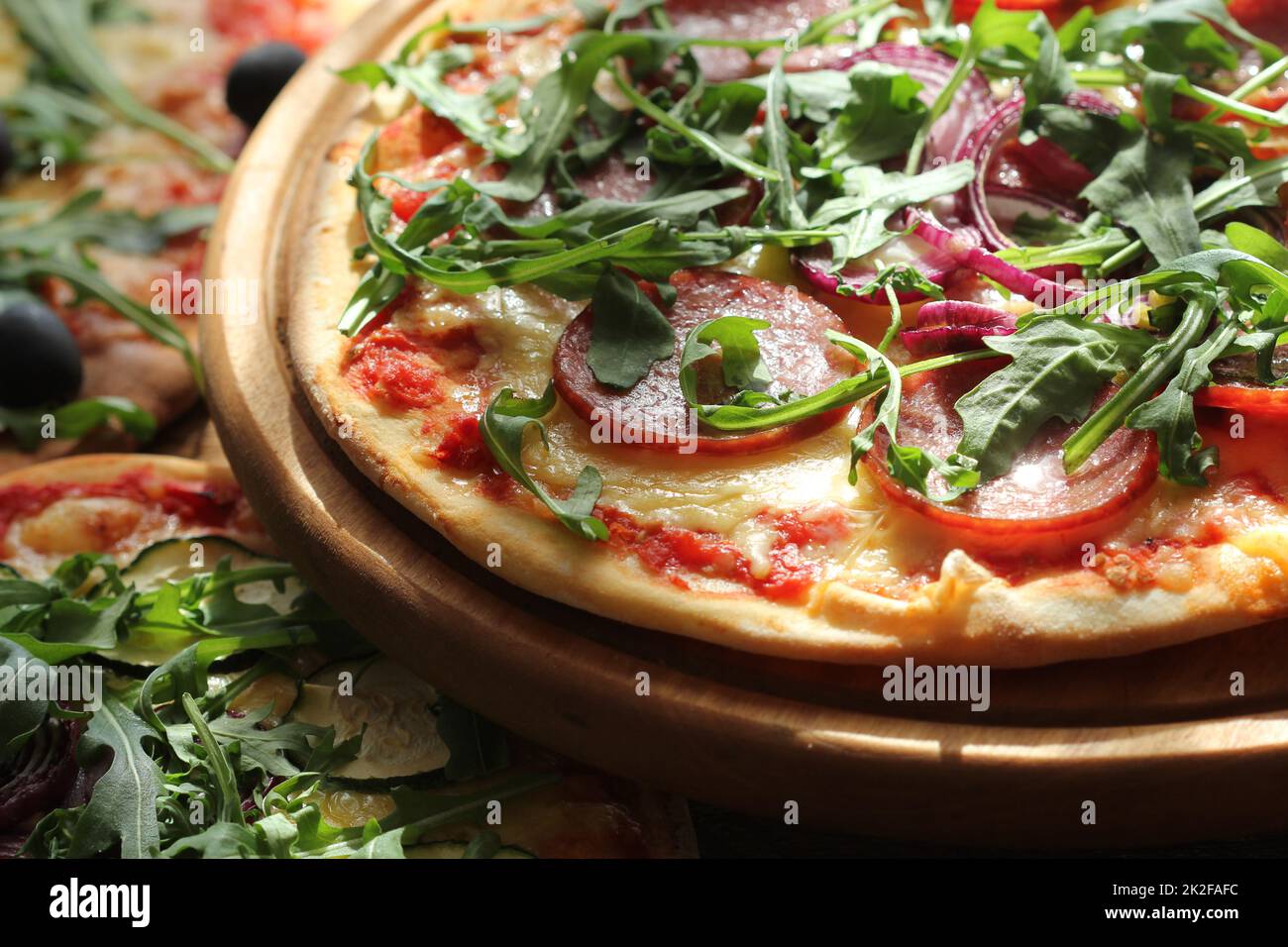 Different variations of pizza.Pizza with sausage, zucchini, olives ...
