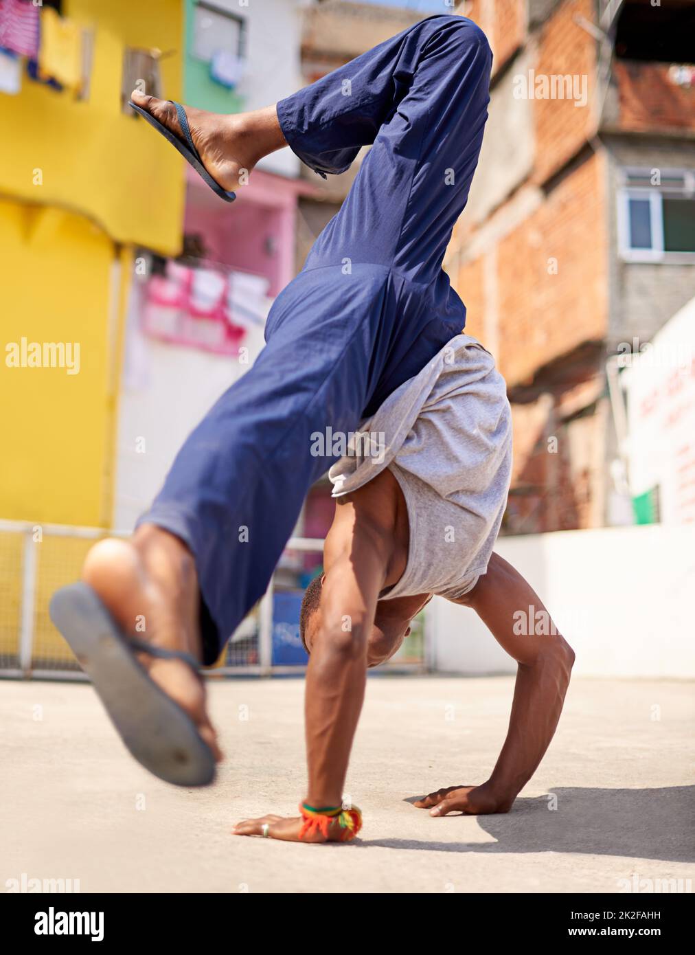 Street style. Low angle shot of a young male breakdancer in an urban setting. Stock Photo