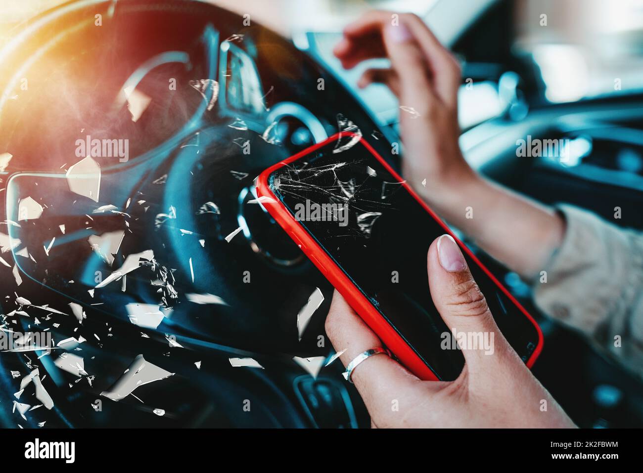 Woman drives dangerously with smartphone in hand Stock Photo
