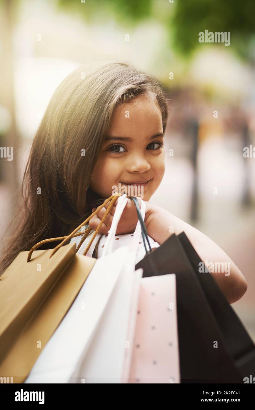 Little girl with shopping bags hi-res stock photography and images - Alamy
