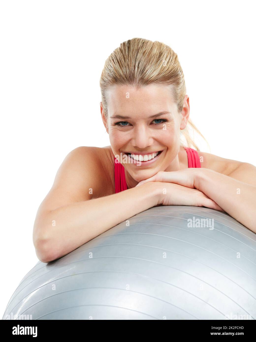 Love yourself a little more. Studio shot of a young woman leaning on her exercise ball. Stock Photo