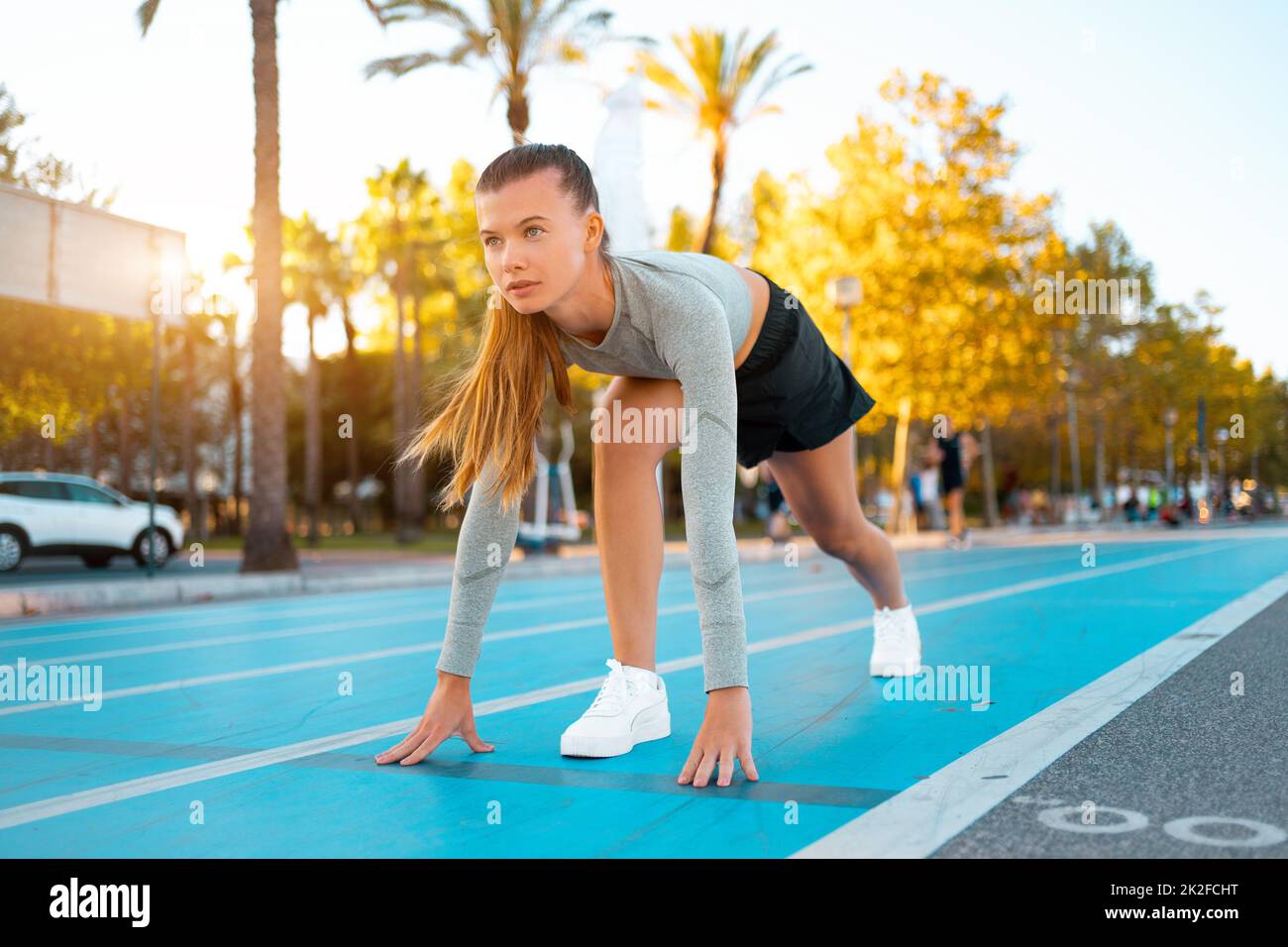 Female athlete ready to run. Fit confident woman starting position