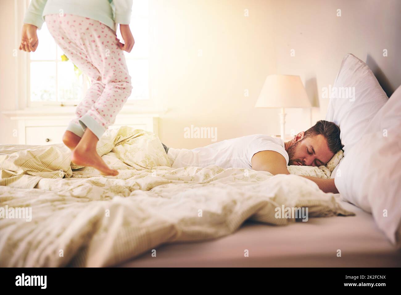A parent never rests. Shot of a cheerful little girl jumping on the bed