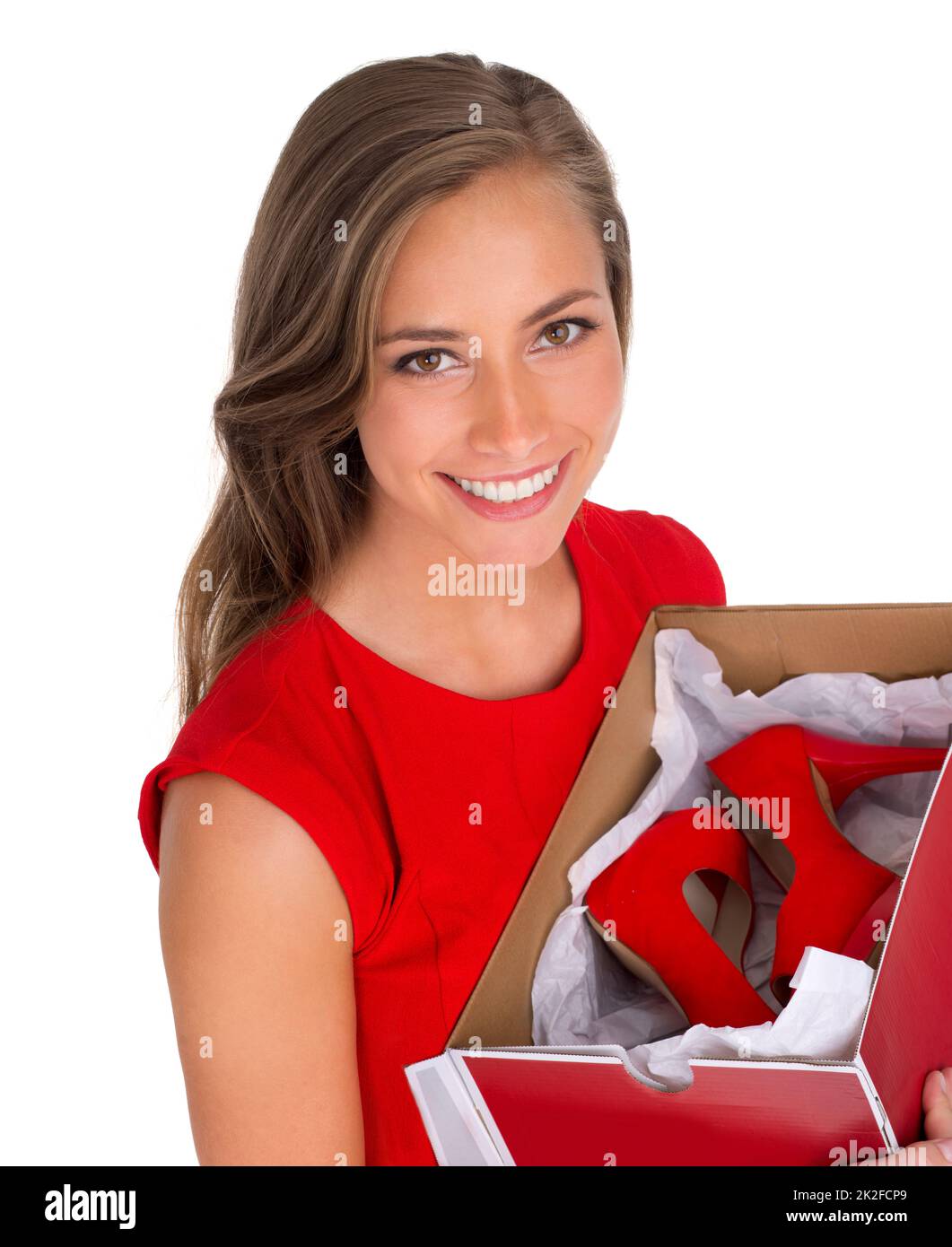 She keeps up to date with the latest fashion trends. High angle shot of an attractive young woman holding a box of new high heels against a white background. Stock Photo