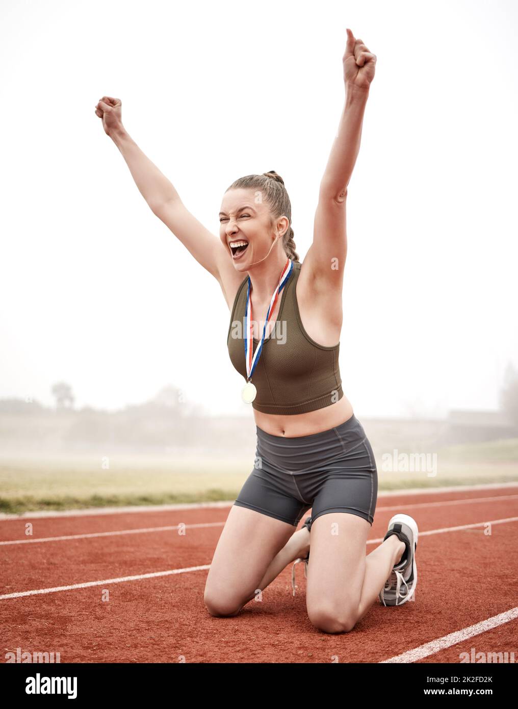 The right attitude will get you far. Shot of a young female athlete celebrating her run. Stock Photo
