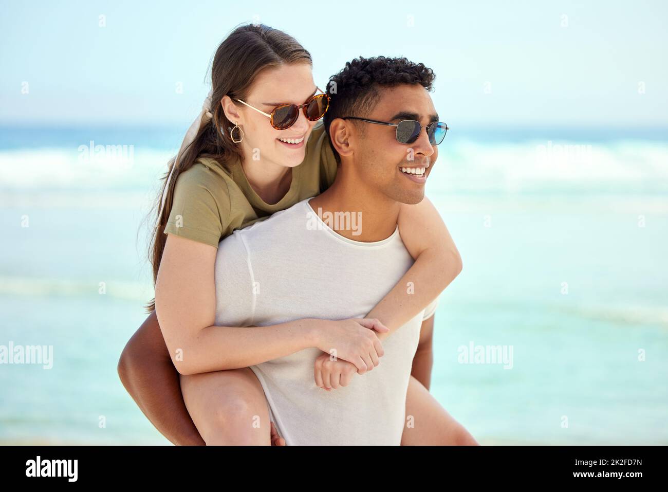 Who doesnt love a summer romance. Shot of a young couple enjoying a day at the beach. Stock Photo