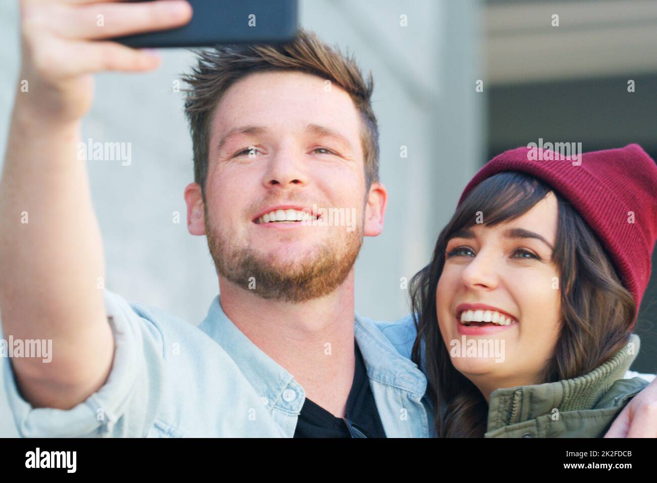 I can picture us side by side forever. Cropped shot of an affectionate young couple taking selfies together outdoors. Stock Photo