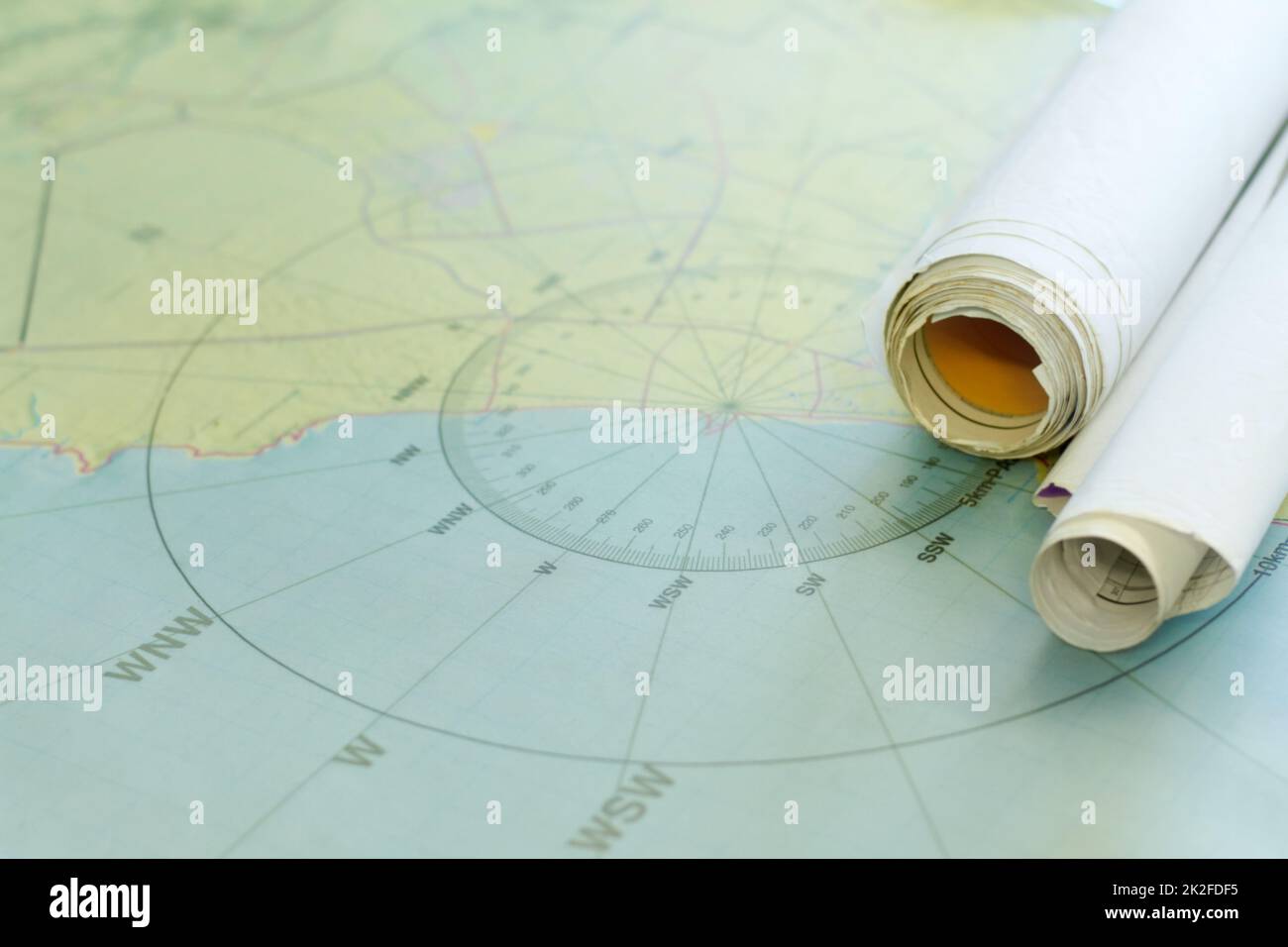 Finding coordinates. Shot of nautical maps on a table. Stock Photo