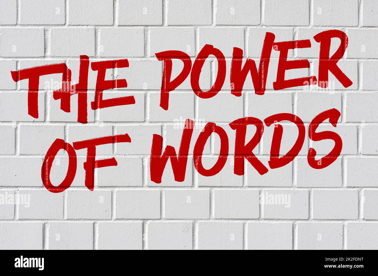 Graffiti on a brick wall - The power of words Stock Photo