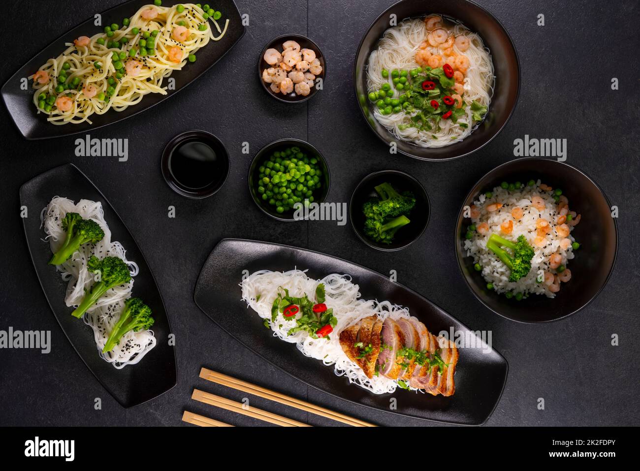 Various dishes of Asian cuisine with different types noodles and rice