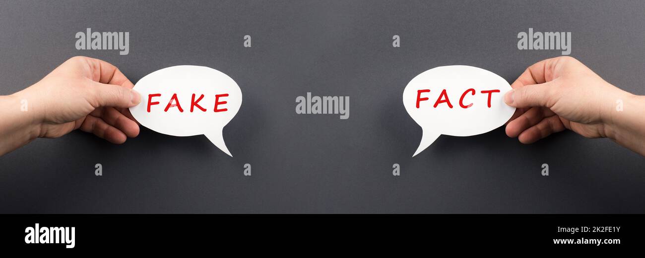 The words fact and fake are standing on a speech bubble, false and true information, media concept Stock Photo