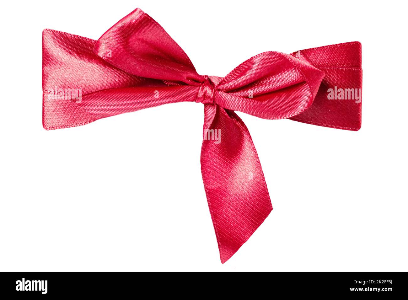 Gift bows. Closeup of a decorative red ribbon bow made of silk for gift box isolated on a white background. Decorations background. Macro photograph. Stock Photo