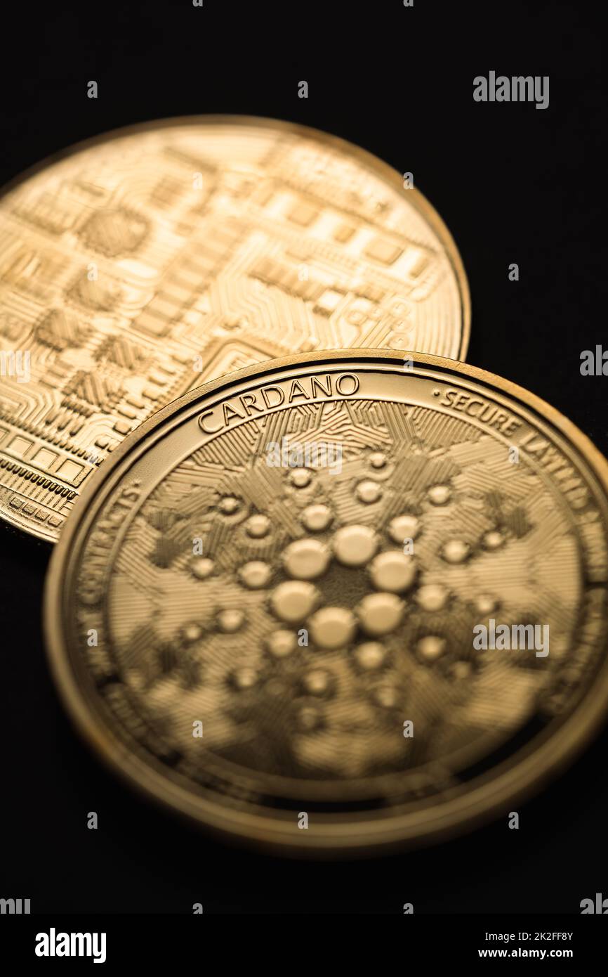 Close up shot of a golden Cardano (ADA) digital cryptocurrency. Stock Photo
