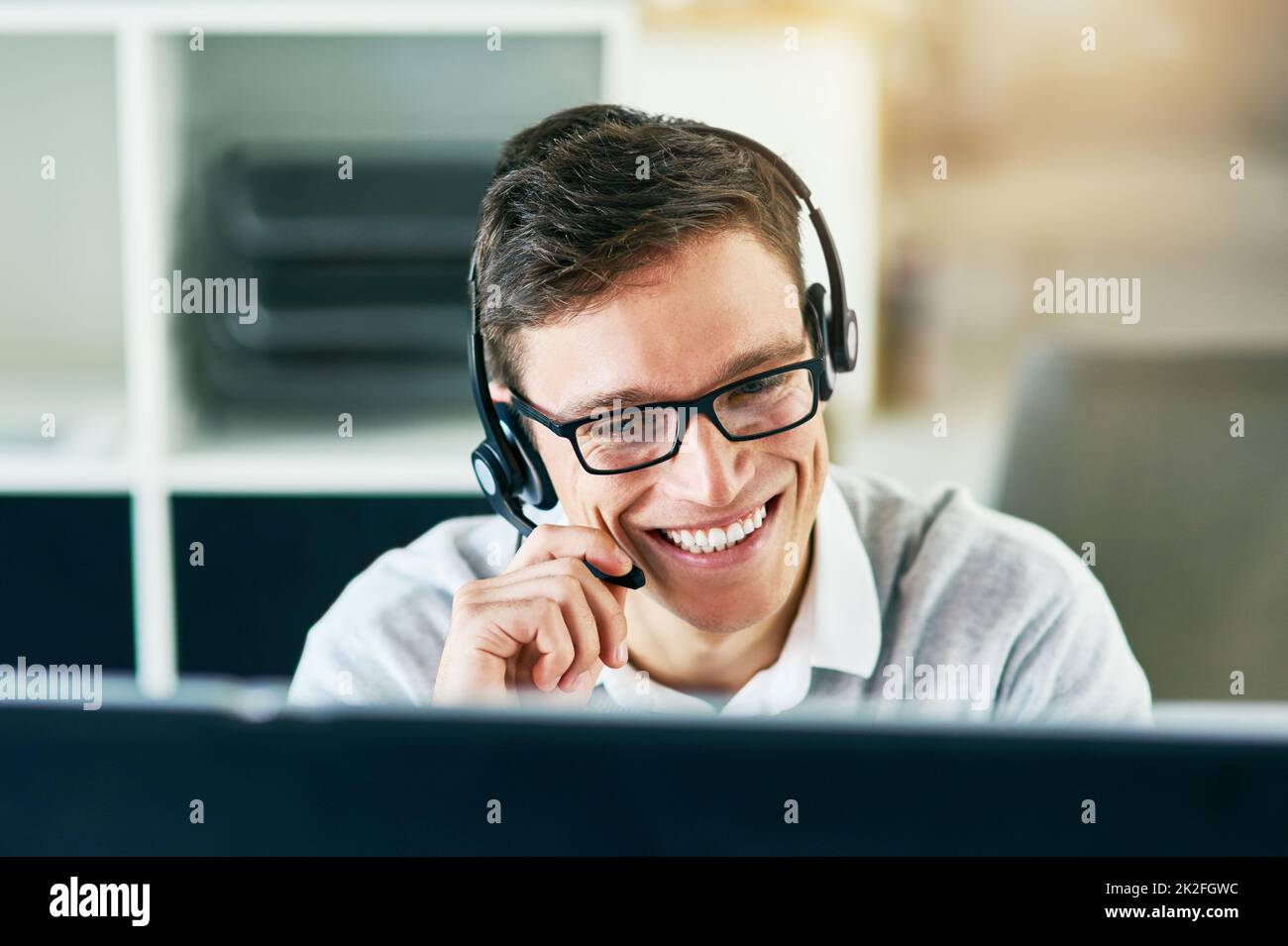 He handles every call with utmost professionalism. Shot of a young call center agent working in an office. Stock Photo