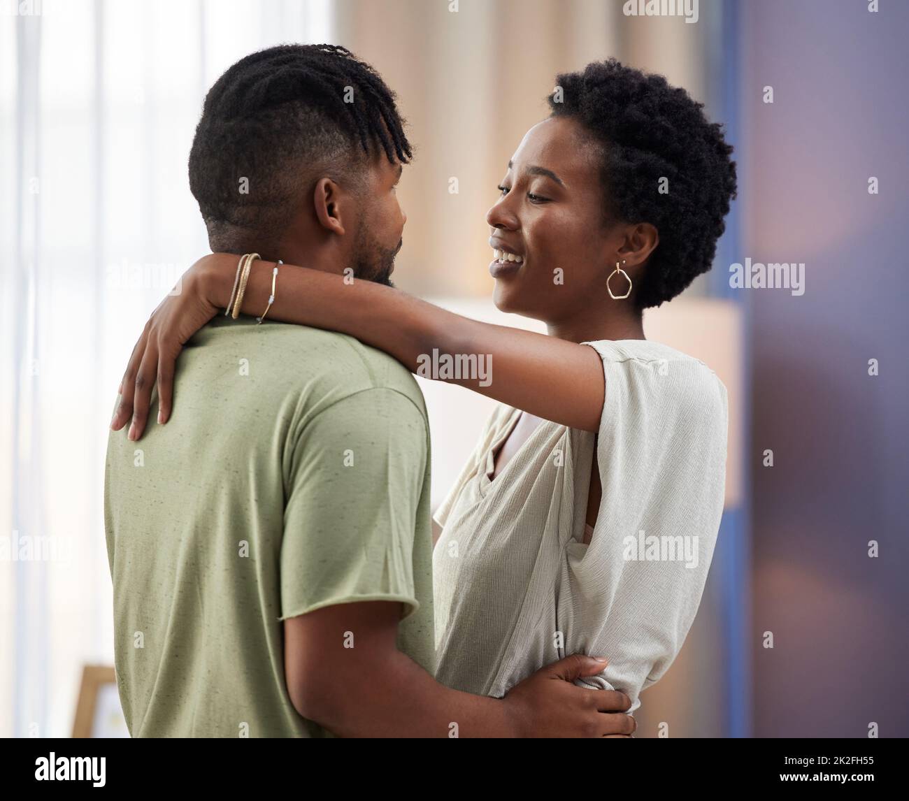 Dance partners for life. Shot of a young couple dancing in the living room at home. Stock Photo
