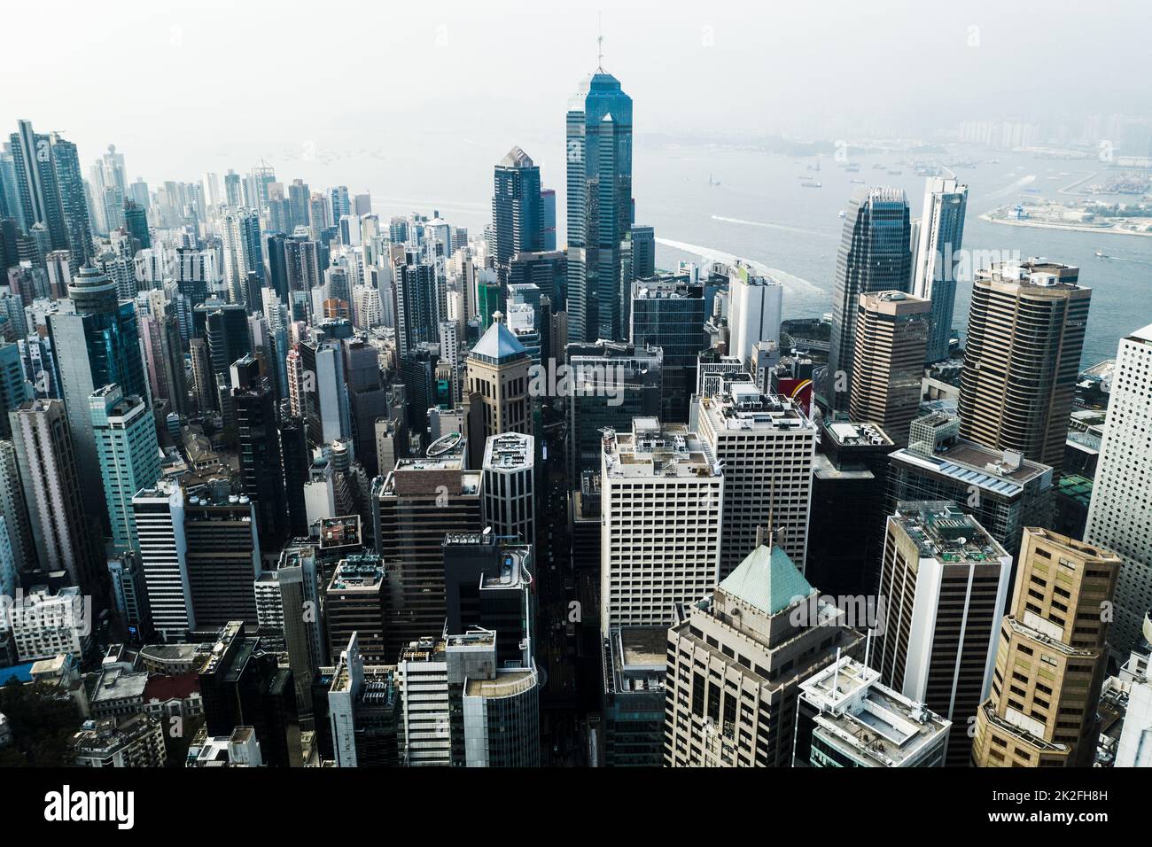 Travel because money returns, time does not. Aerial shot of skyscrapers, office blocks and other commercial buildings in a busy coastal city. Stock Photo