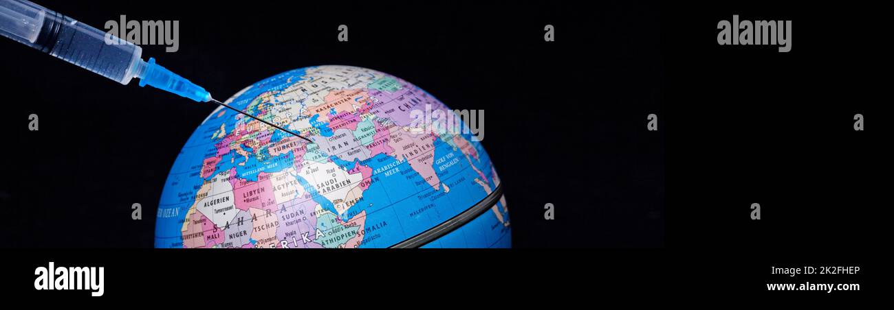 Medical syringe with a needle vaccinated the planet Earth. Stock Photo