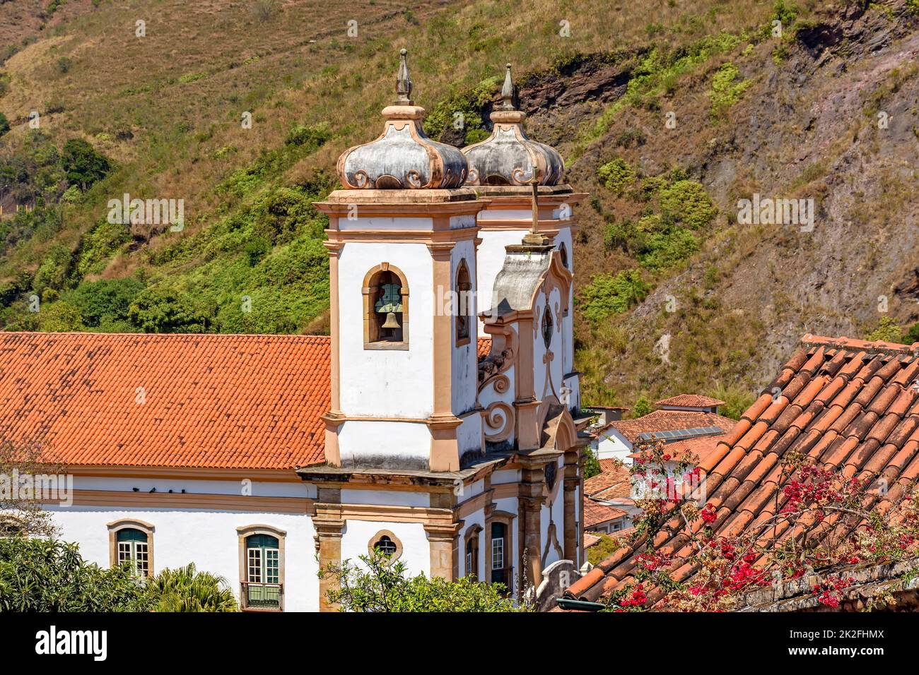 Side view of historic church in baroque and colonial style from the 18th century amid the hills and vegetation Stock Photo