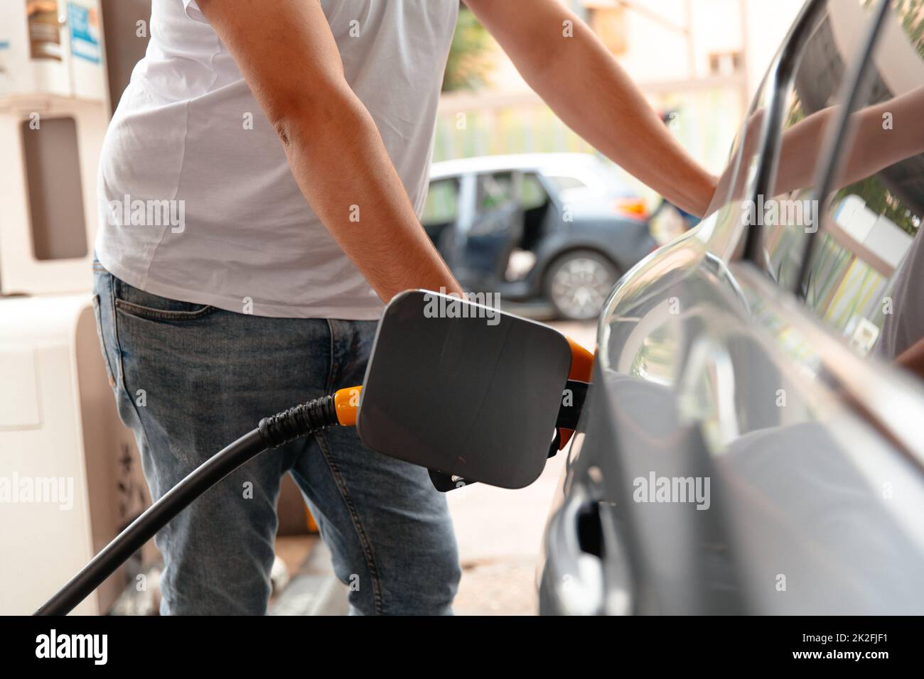 Hand Man Refill and filling Oil Gas Fuel at station. Car fill with gasoline at a gas station. Gas station pump. Stock Photo