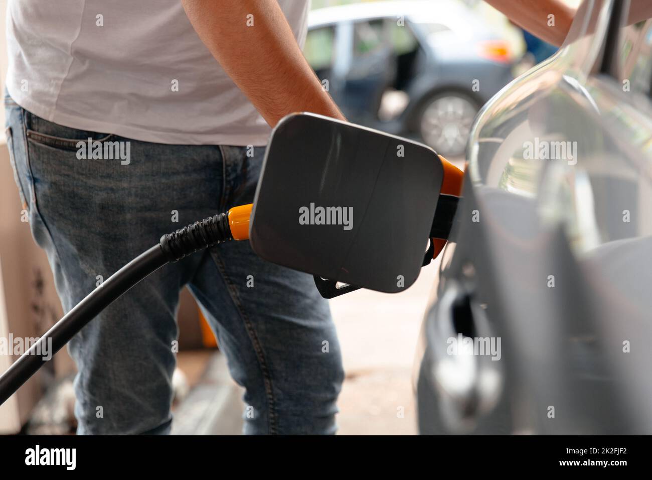 Hand Man Refill and filling Oil Gas Fuel at station. Car fill with gasoline at a gas station. Stock Photo