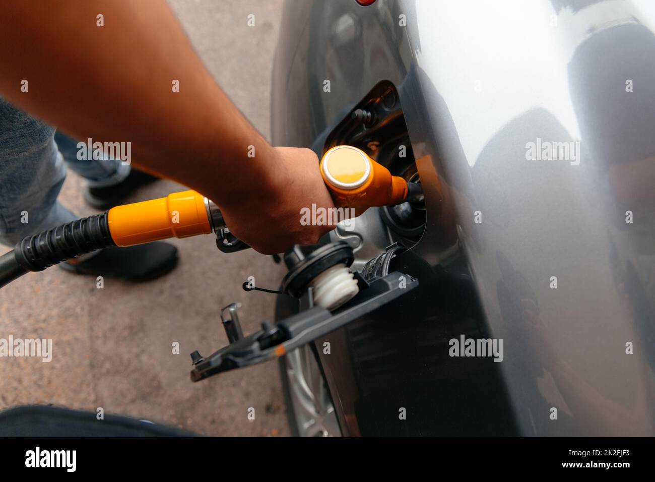 Hand Man Refill and filling Oil Gas Fuel at station. Refueling automobile with gasoline or diesel with a fuel dispenser. Fuel business Stock Photo
