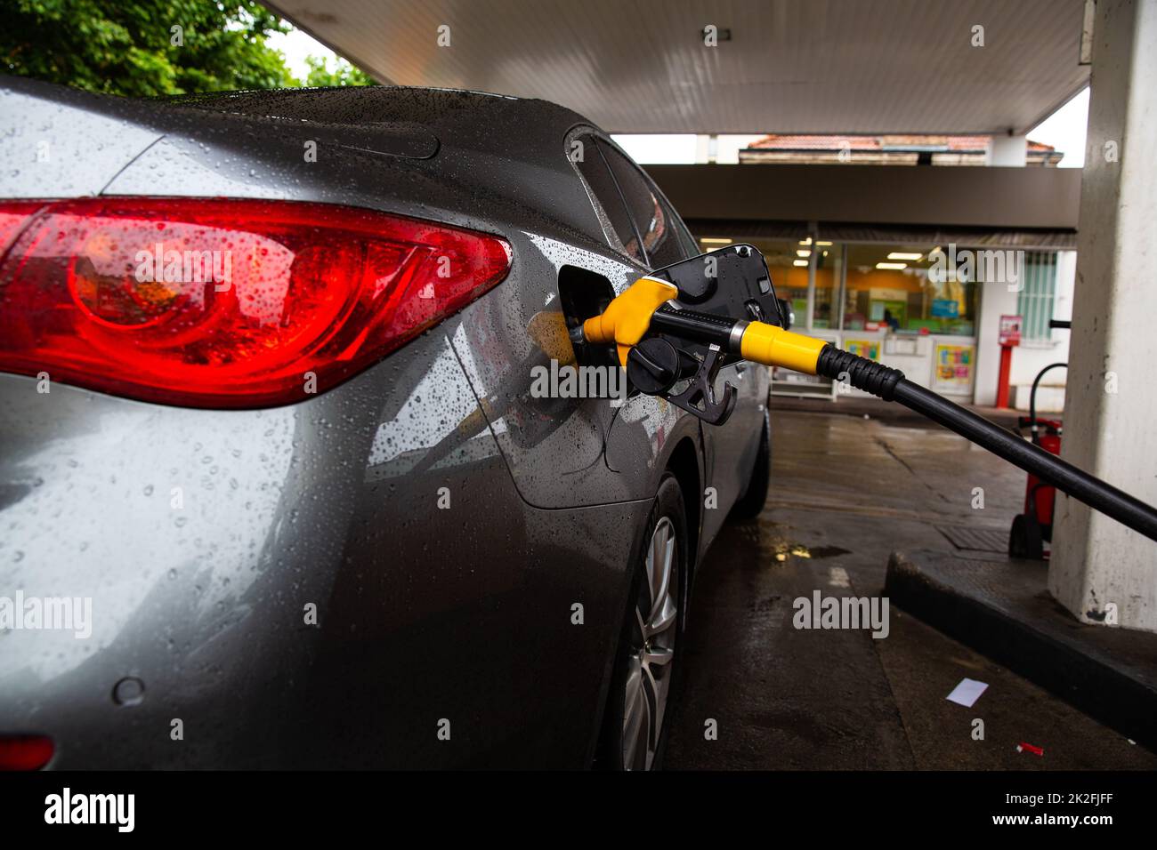 The car is refueling at the gas station. Refueling automobile with gasoline or diesel with a fuel dispenser. Stock Photo