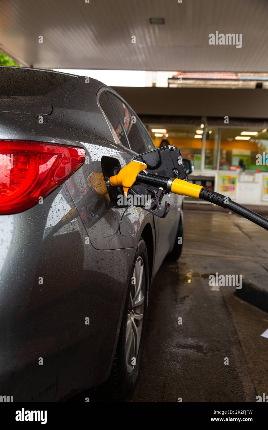 Pumping gasoline fuel in car at gas station. Car refueling fuel on