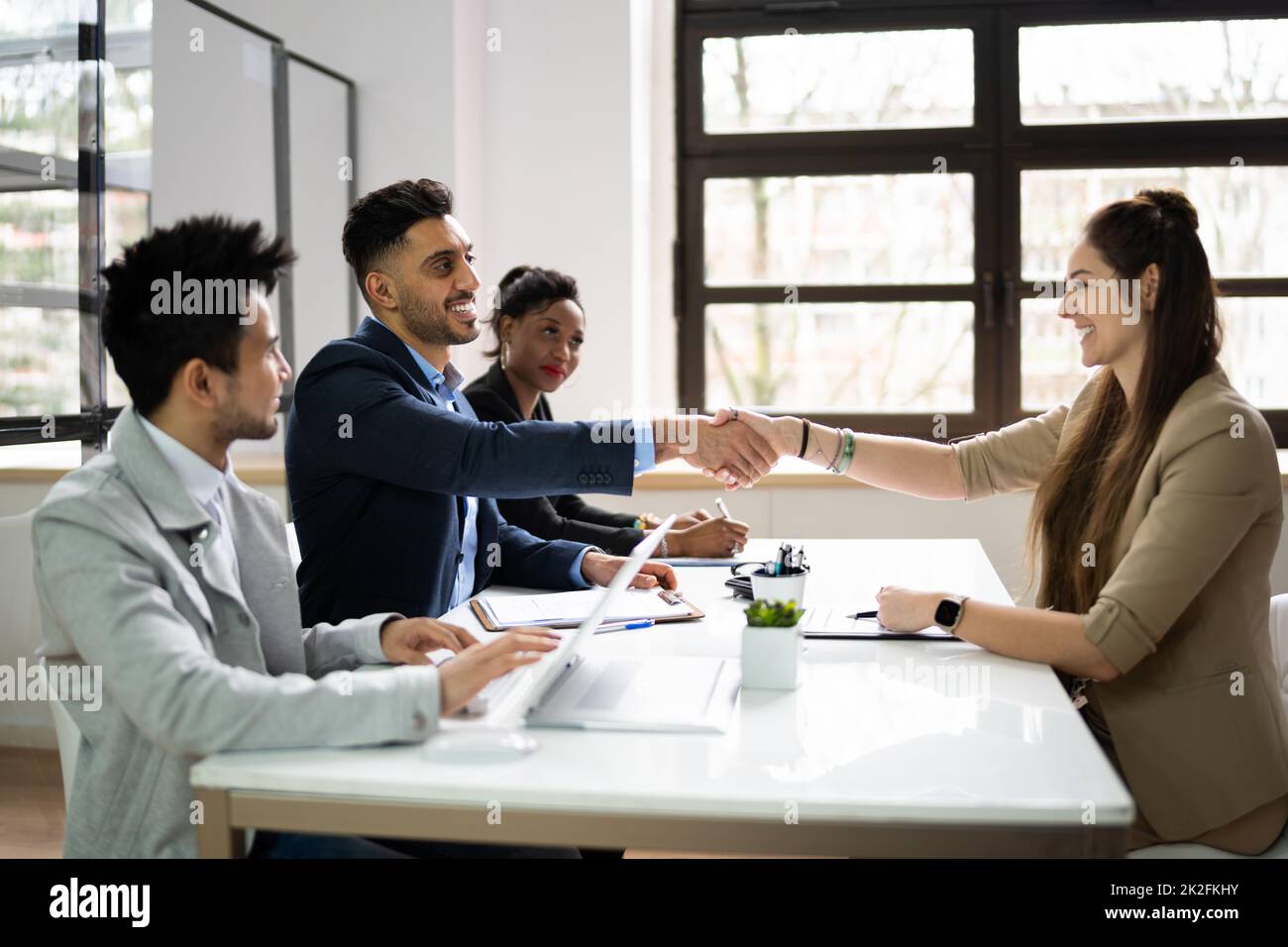 Businesspeople Shaking Hands After Interview Stock Photo