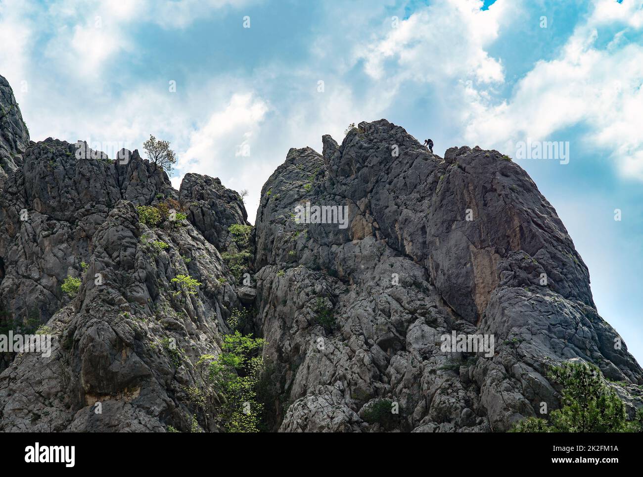 Paklenica, Croatia, EU - June 25, 2022: Distant view of mountain climber in national park Paklenica. Stock Photo
