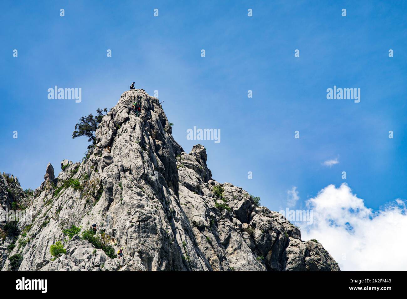 Paklenica, Croatia, EU - June 25, 2022: Distant view of mountain climbers in national park Paklenica. Stock Photo