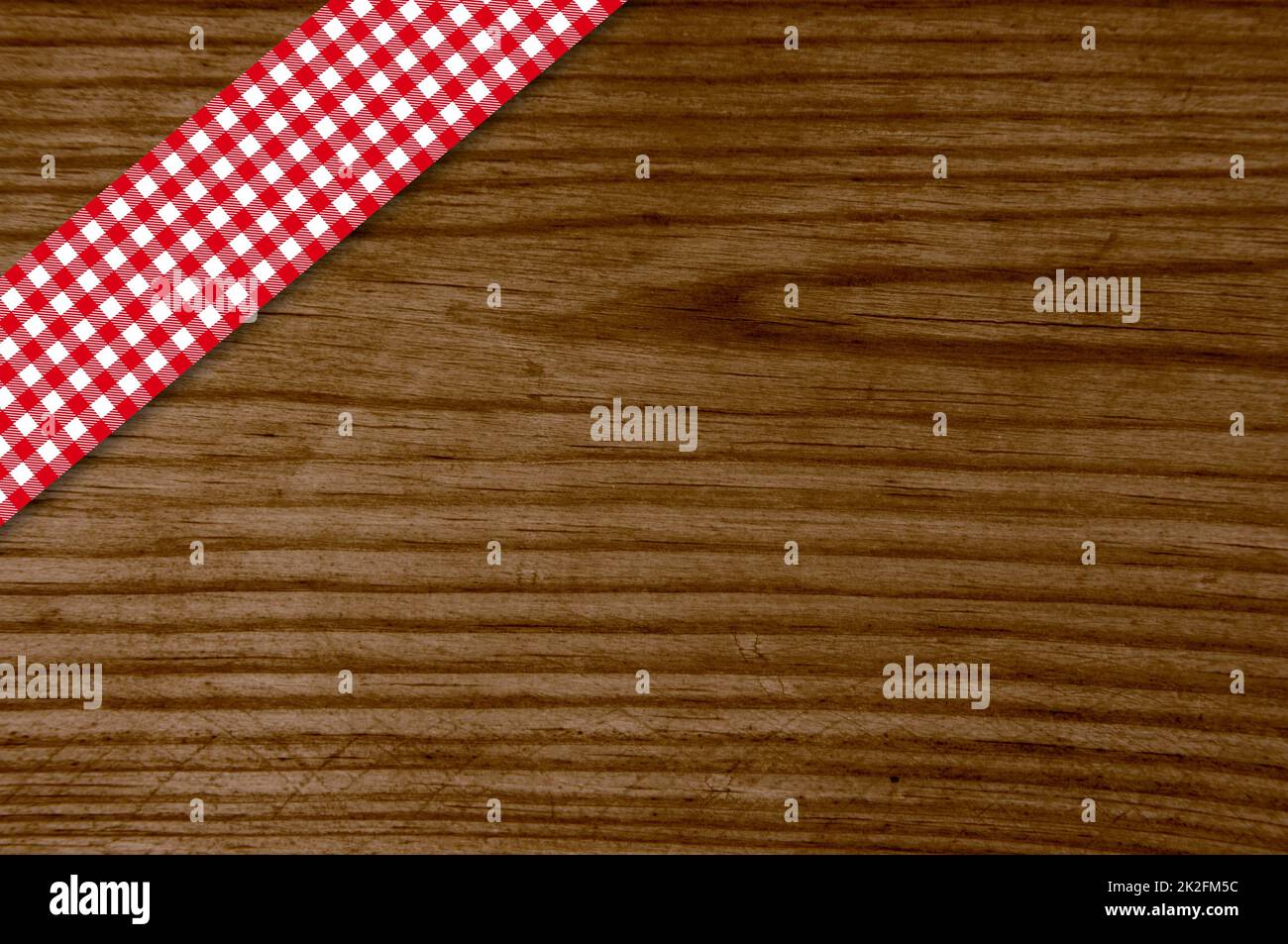 Red tablecloth stripe on old wooden board Stock Photo