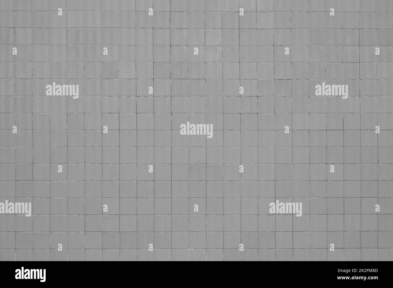 Grunge wall with grey tiles Stock Photo