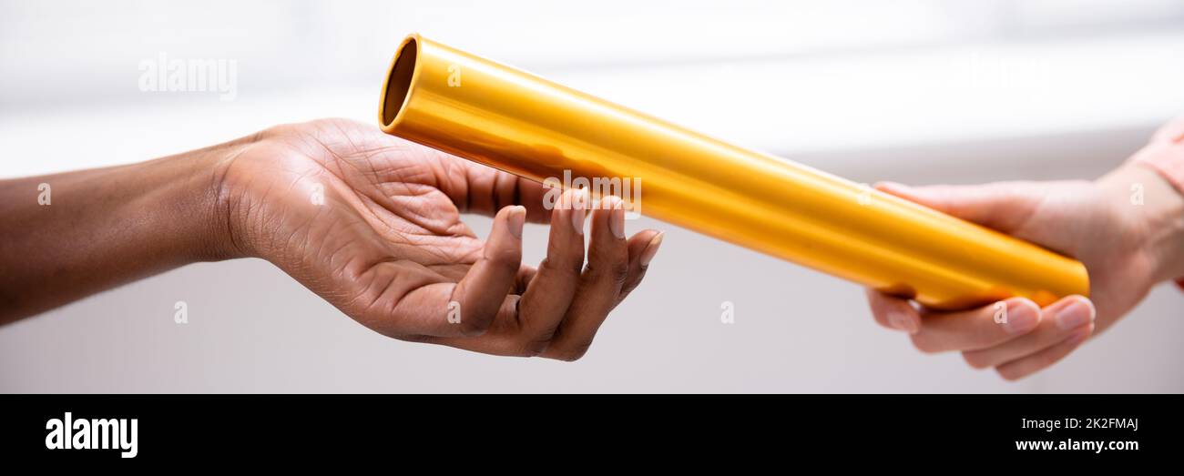 Passing Golden Relay Baton To Other Person Stock Photo Alamy