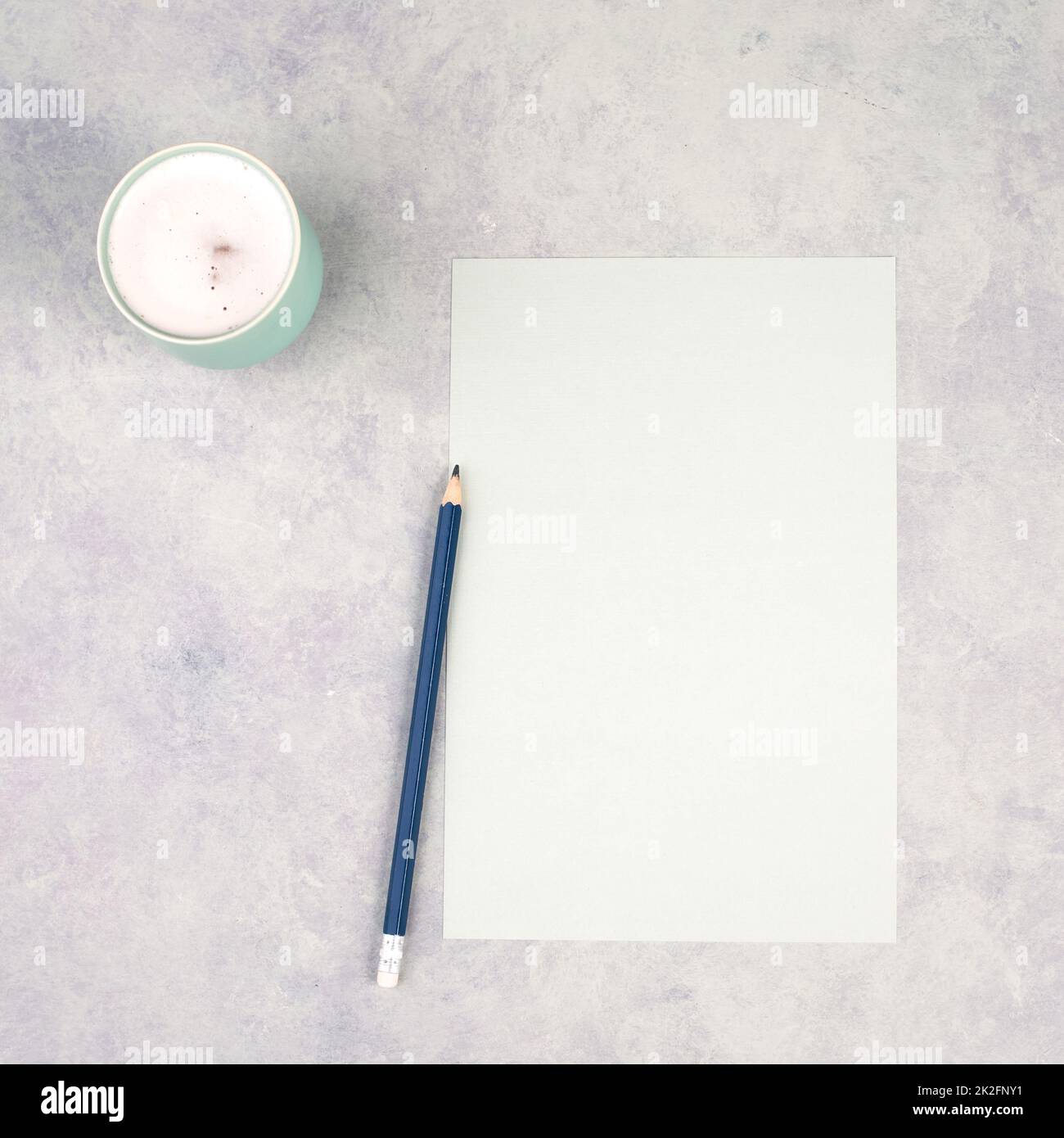 Empty paper with a pen and a cup of coffee, textured background, brainstorming for new ideas, writing a message, taking a break, home office desk Stock Photo