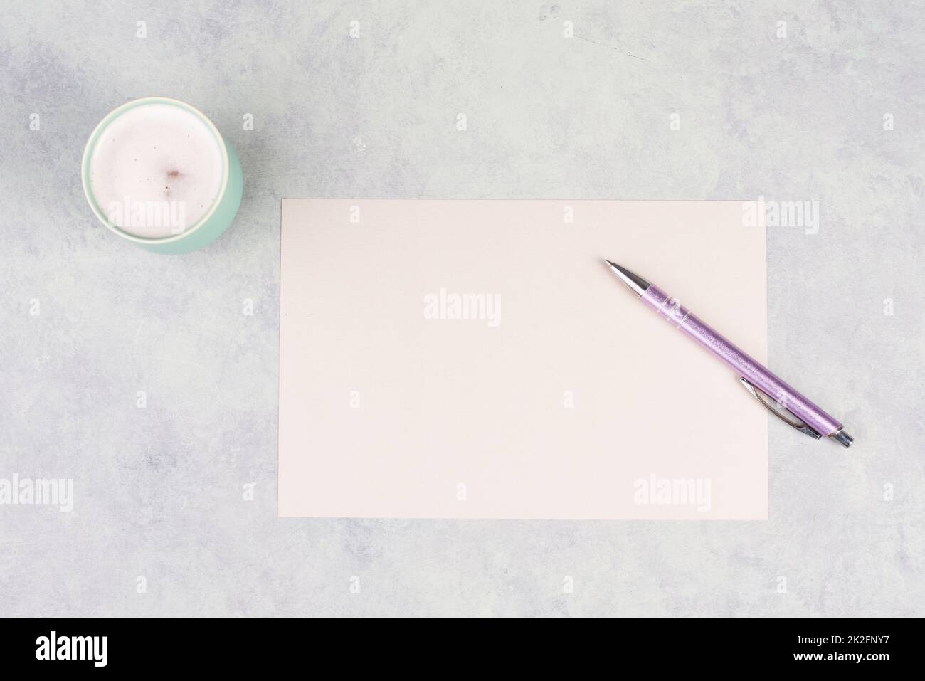 Empty paper with a pen and a cup of coffee, textured background, brainstorming for new ideas, writing a message, taking a break, home office desk Stock Photo