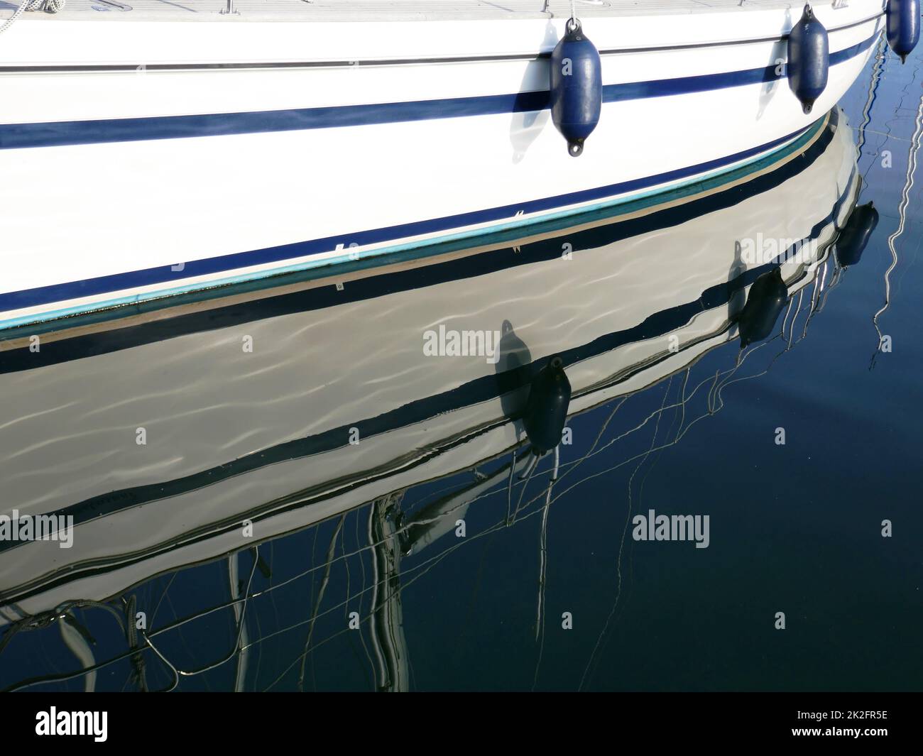 Sailboat reflected in the water Stock Photo - Alamy
