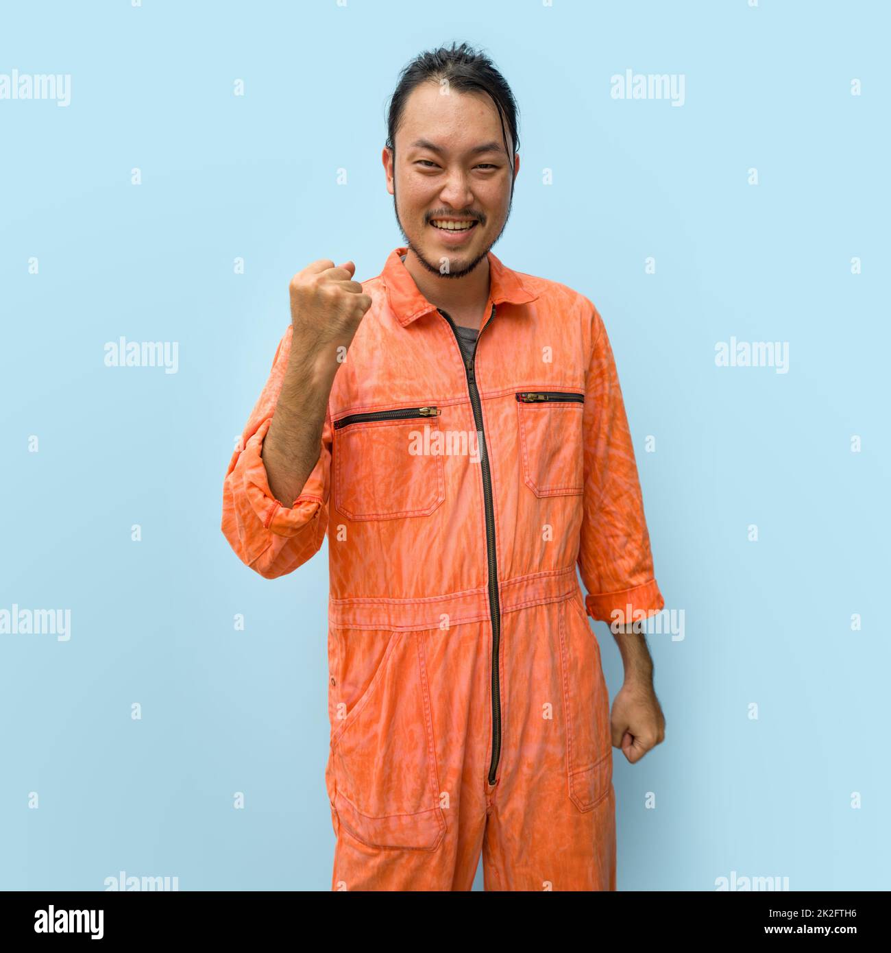 Young long hair asian man with mustache and beard stand smiling while