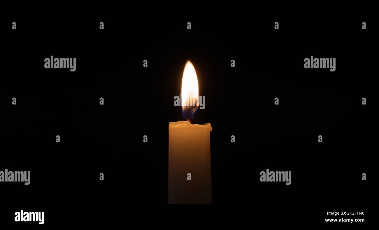 Burning candle in the darkness Stock Photo Alamy