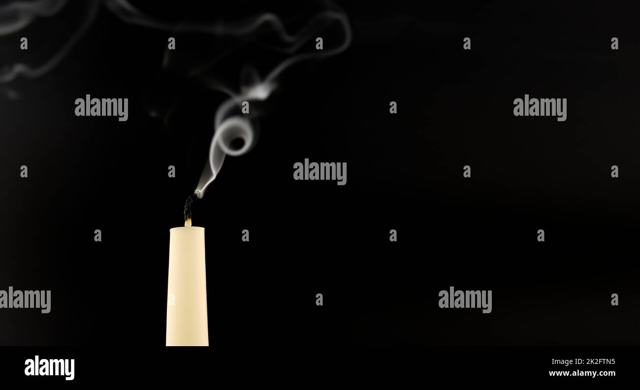 Blown out candle over a black background Stock Photo Alamy