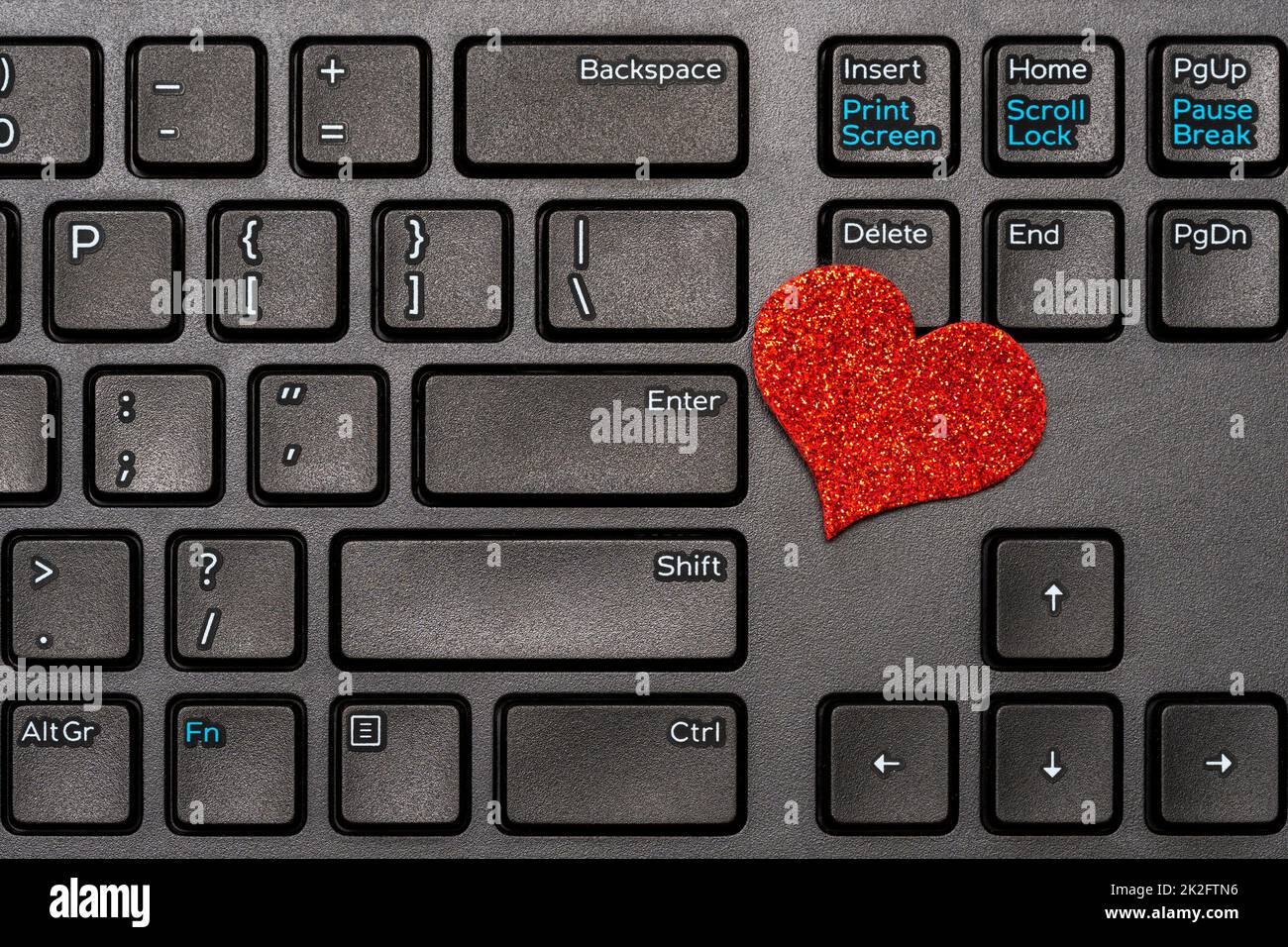 Valentines Day theme,red heart on laptop keyboard Stock Photo